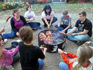 Roasting hotdogs.